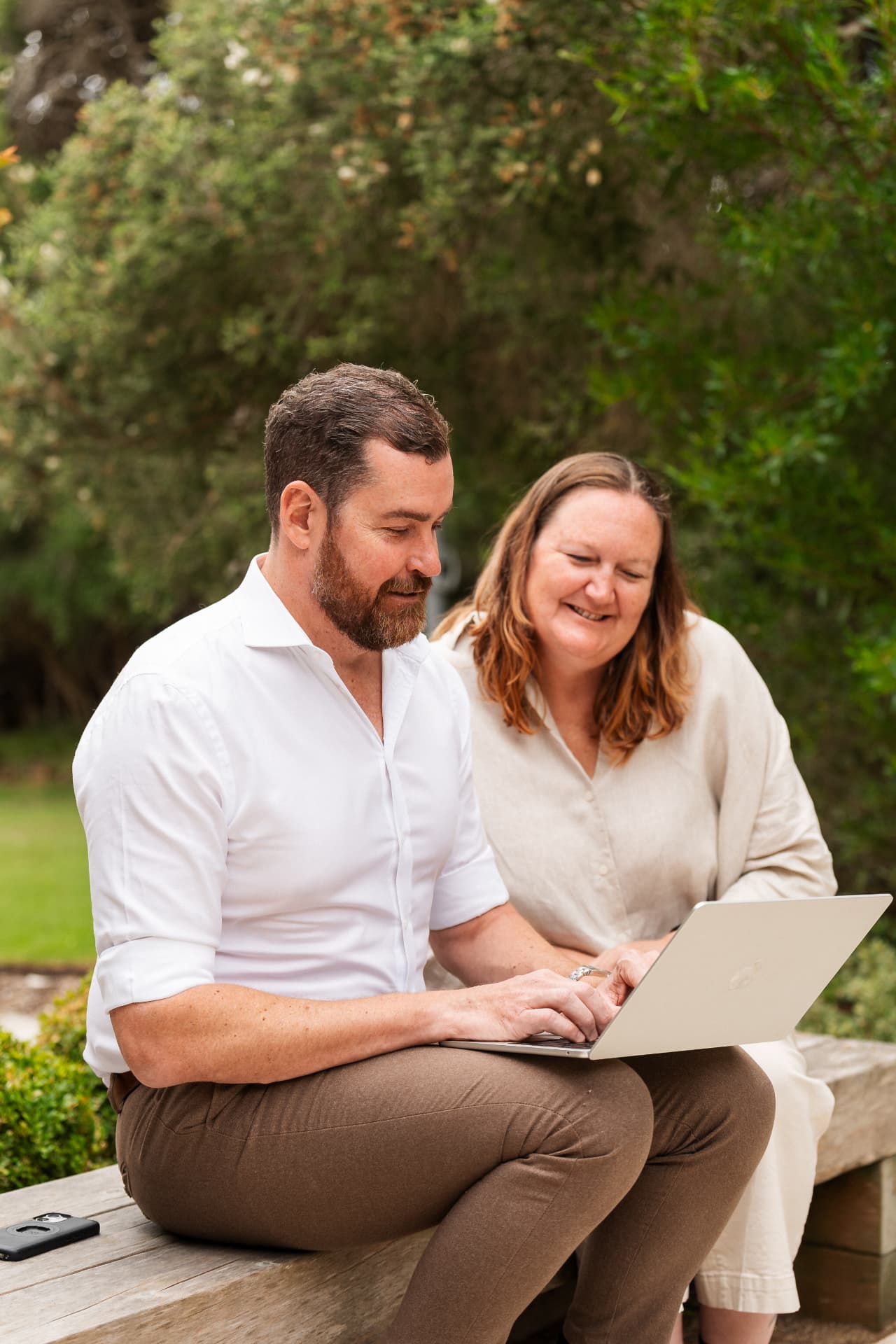 Two Future Finance Group team members reviewing a client plan on a laptop